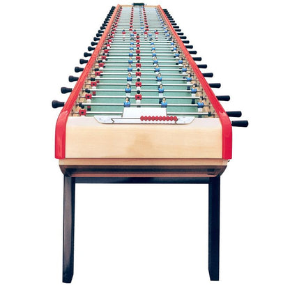 Oversized foosball table with multiple rods and red trim on white background